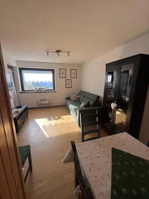 a living room with a couch and a table at Chez Mati by Sunhome Fiemme in Cavalese