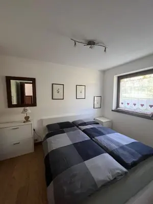 a bedroom with a large bed and a window at Chez Mati by Sunhome Fiemme in Cavalese