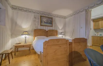 a bedroom with a bed and a table and two lamps at Monolocale romantico tra le vette di Cortina in Cortina dʼAmpezzo