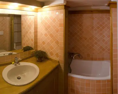 a bathroom with a sink and a bath tub at Monolocale romantico tra le vette di Cortina in Cortina dʼAmpezzo