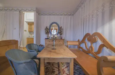 a dining room with a table and chairs and a mirror at Monolocale romantico tra le vette di Cortina in Cortina dʼAmpezzo