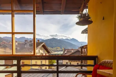 a window with a view of a mountain at Appartamento Al Cirmolo - 4 Camere in Pieno Centro di Fiera di Primiero in Fiera di Primiero