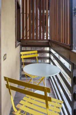 a table and two chairs on a balcony at Appartamento Al Cirmolo - 4 Camere in Pieno Centro di Fiera di Primiero in Fiera di Primiero