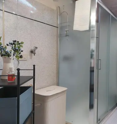 a bathroom with a toilet and a glass shower at Sole & Luna Dolomiti House in Voltago
