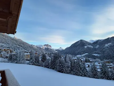 a view from the balcony of a ski resort in the mountains at Casa Davarda - Appartamento Cima Dodici in Vigo di Fassa