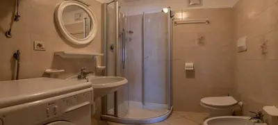 a bathroom with a shower and a sink and a toilet at Casa Davarda - Appartamento Cima Dodici in Vigo di Fassa