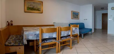 a dining room with a table and chairs at Casa Davarda - Appartamento Cima Dodici in Vigo di Fassa