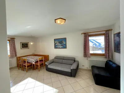 a living room with a couch and a table at Casa Davarda - Appartamento Lusia in Vigo di Fassa