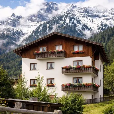 a house in front of a mountain at Casa vacanze Danoi Dolomiti in Canale dʼAgordo