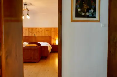 a hallway leading to a bedroom with a bed at Casa vacanze Danoi Dolomiti in Canale dʼAgordo