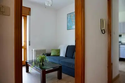 a living room with a blue couch and a table at Casa vacanze Danoi Dolomiti in Canale dʼAgordo