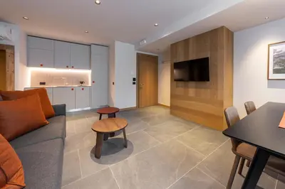 a living room with a couch and a table at Dolomiten Apartments in Tesero