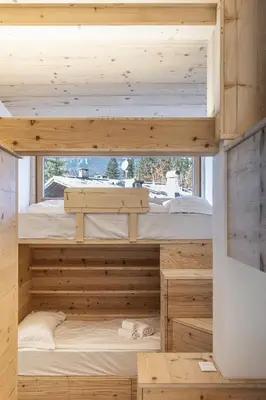 a room with two bunk beds in it at Casa Poligrafica 1 in Cortina dʼAmpezzo