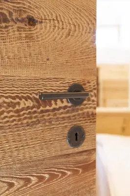 a wooden door with a lock on it at Casa Poligrafica 1 in Cortina dʼAmpezzo