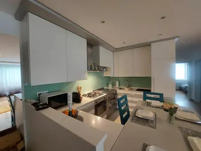 a kitchen with white cabinets and a counter top at Casa Evelina con Parcheggio esterno e Garage gratis, appartamento con idromassaggio per due in Sanzeno