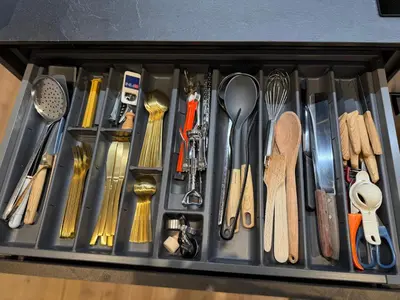 a drawer filled with lots of different types of utensils at SciaLet in Campitello di Fassa