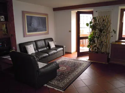 a living room with a couch and a chair at Luigi Apartment in Varena