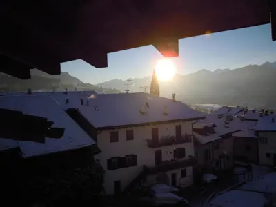 a view from a window of a city with the sunset at Luigi Apartment in Varena