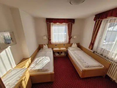 two beds in a small room with windows at Chalet Milandora in La Villa