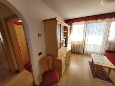 a living room with a cabinet and a table at Chalet Milandora in La Villa