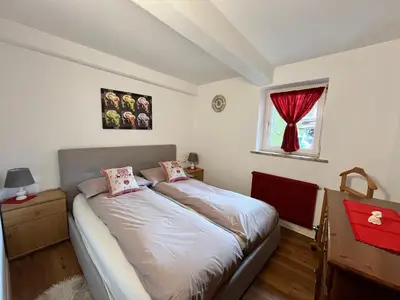 a bedroom with a bed and a window at Casa Angela in Cavalese