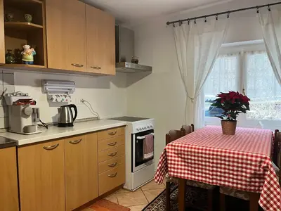 a kitchen with a table with a table cloth on it at Casa Angela in Cavalese