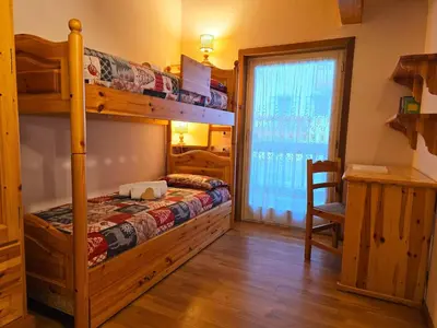 a view from a balcony of a town in the mountains at Attico Lagorai - Alpine Stay Apartments in Ziano di Fiemme