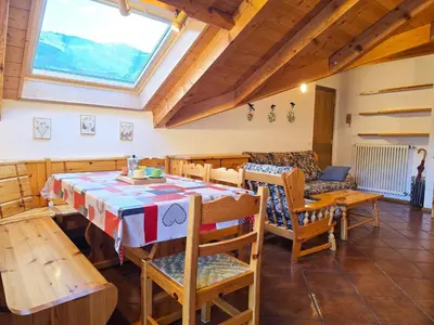 a kitchen and dining room with a table and chairs at Attico Lagorai - Alpine Stay Apartments in Ziano di Fiemme