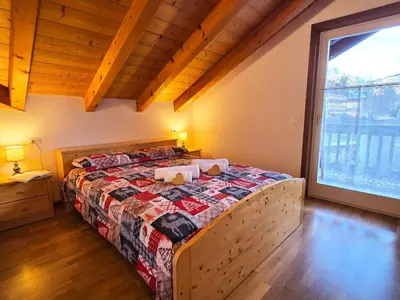 a view from a balcony of a town with snow at Attico Lagorai - Alpine Stay Apartments in Ziano di Fiemme