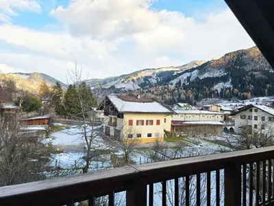 a bedroom with a bed and a large window at Attico Lagorai - Alpine Stay Apartments in Ziano di Fiemme