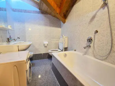 a bedroom with a bed with towels on it at Attico Lagorai - Alpine Stay Apartments in Ziano di Fiemme