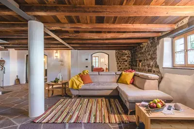 a living room with a couch and a table at Maso Via Vecchia in Ora/Auer