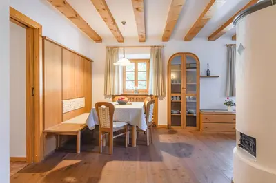 a kitchen and dining room with a table and chairs at Maso Via Vecchia in Ora/Auer