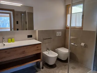 a bathroom with a sink and a toilet and a shower at Reitererhof in Hafling