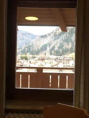 a window with a view of a mountain at Appartamento Casa Latemar in Predazzo