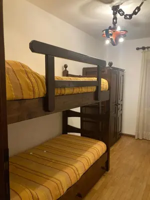 two bunk beds in a room with a ceiling at Appartamento Casa Latemar in Predazzo