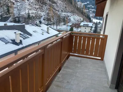 a balcony with a view of a snow covered mountain at Appartamento Casa Latemar in Predazzo