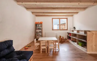 a room with a table and chairs and a couch at Großplonerhof in Luson