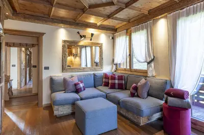 a living room with a couch and a table at Casa Maddalena, quiet and very comfortable in Cortina dʼAmpezzo