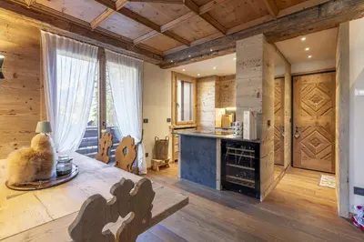 a living room with wooden walls and wooden flooring at Casa Maddalena, quiet and very comfortable in Cortina dʼAmpezzo