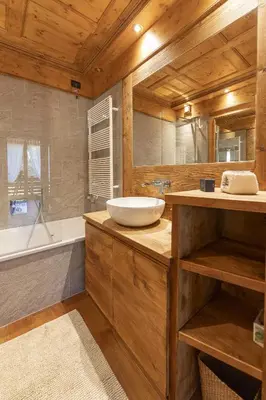 a bathroom with a sink and a tub and a mirror at Casa Maddalena, quiet and very comfortable in Cortina dʼAmpezzo