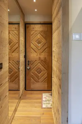 a wooden door in a hallway with wooden floors at Casa Maddalena, quiet and very comfortable in Cortina dʼAmpezzo