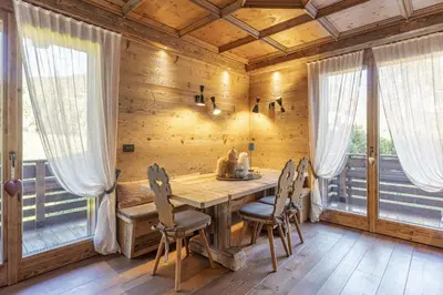 a wooden dining room with a table and chairs at Casa Maddalena, quiet and very comfortable in Cortina dʼAmpezzo