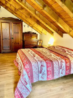 a bedroom with a bed and a wooden ceiling at Ca Novella Apartment in San Vito di Cadore
