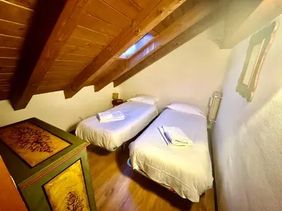 a room with two beds in a room with at Ca Novella Apartment in San Vito di Cadore
