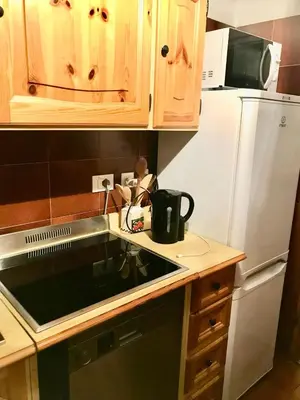 a kitchen with a sink and a white refrigerator at Ca Novella Apartment in San Vito di Cadore