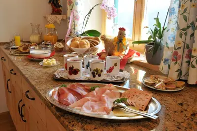 a table with plates of food on a counter at Prantschurhof in San Pietro in Gardena