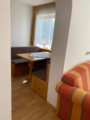 a living room with a table and a couch at Prantschurhof in San Pietro in Gardena