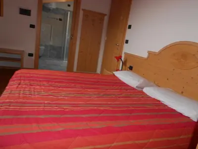 an attic bathroom with a toilet and a shower at Appartamento Agritur nel Verde in Brez