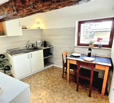 a small kitchen with a table and a sink at Maison Cavalese - Polar Express in Cavalese